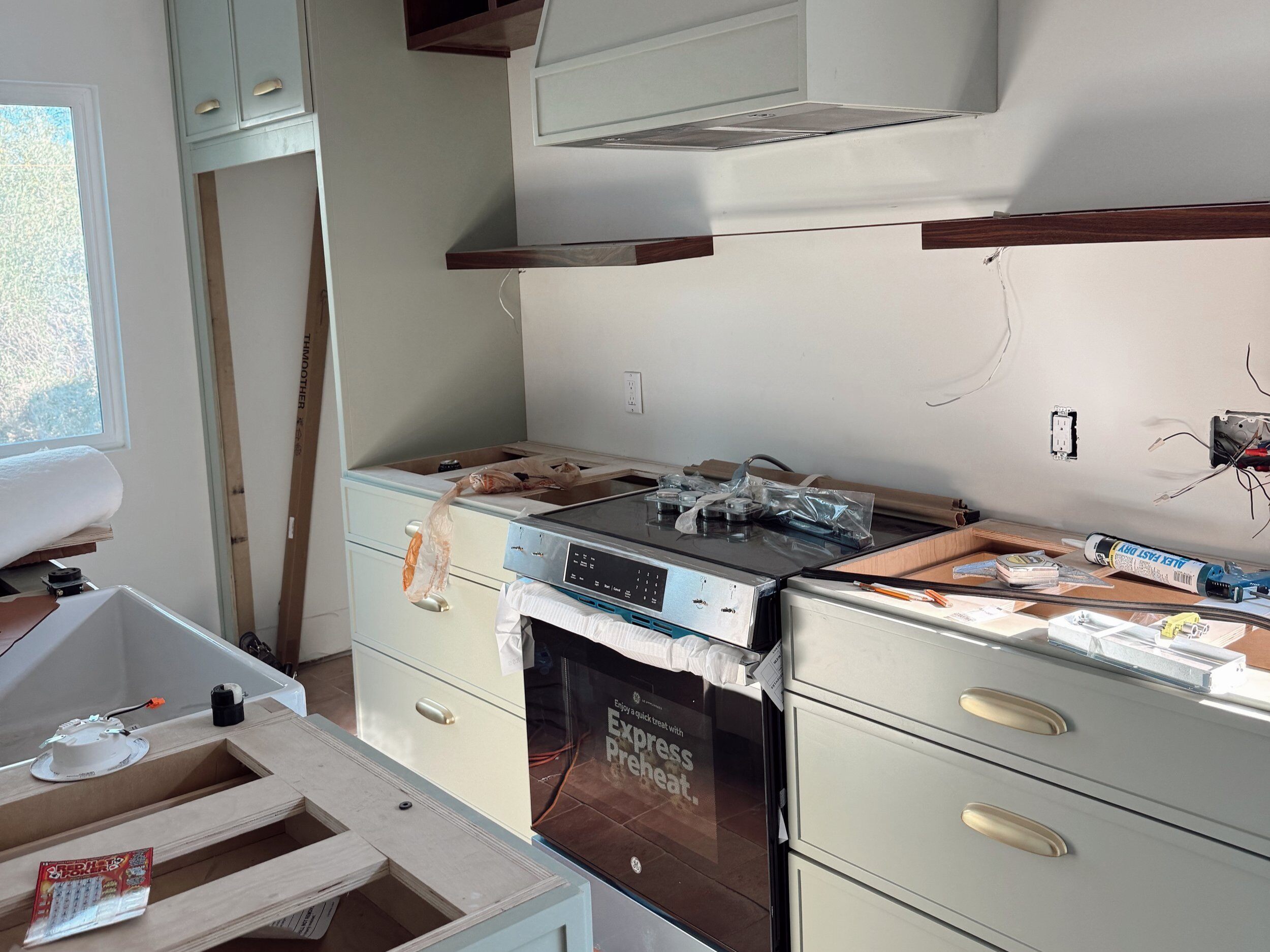 Sage green kitchen under construction by Honeycomb Design and Build in Mission Hills San Diego